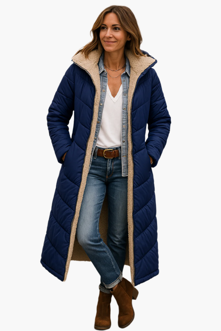 Adeline hooded longline puffer jacket in navy, front view with hands in pockets