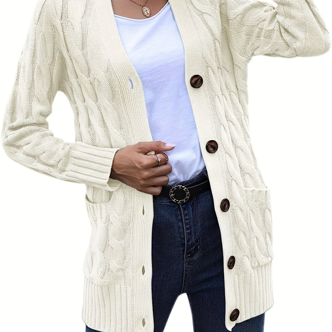 Delphine cable knit cardigan in off-white, front view with belt and jeans