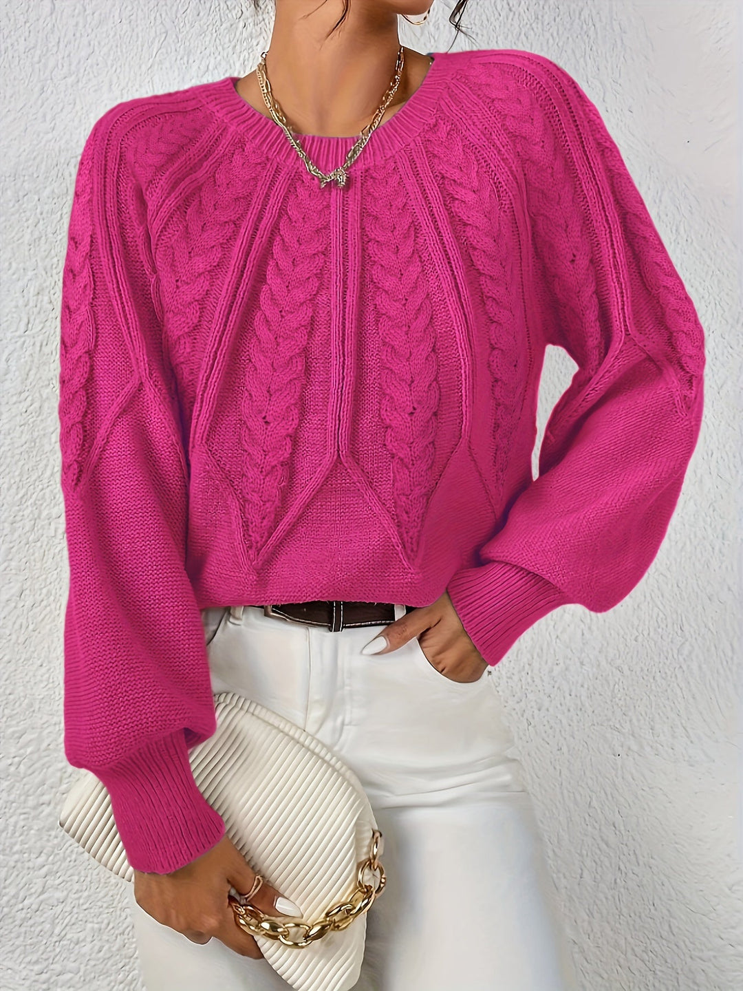 Elowen rose red cable-knit round-neck sweater, front view with handbag