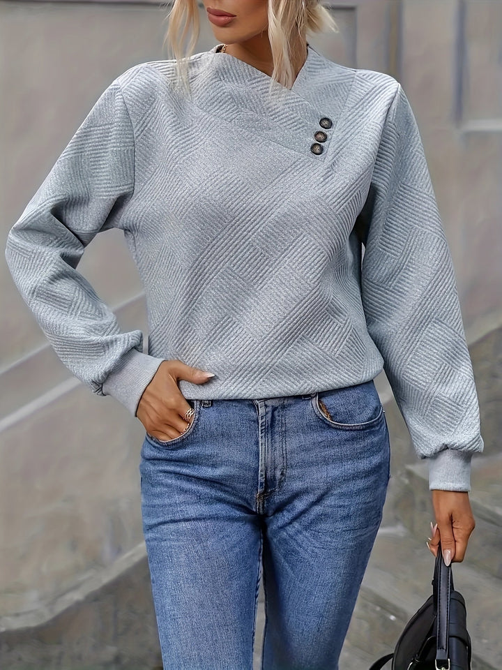 Everly asymmetrical button neck sweater, front view with handbag