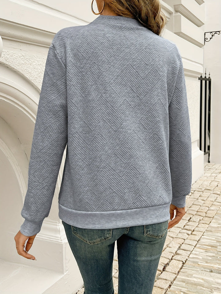 Everly asymmetrical button neck sweater, front view close hands