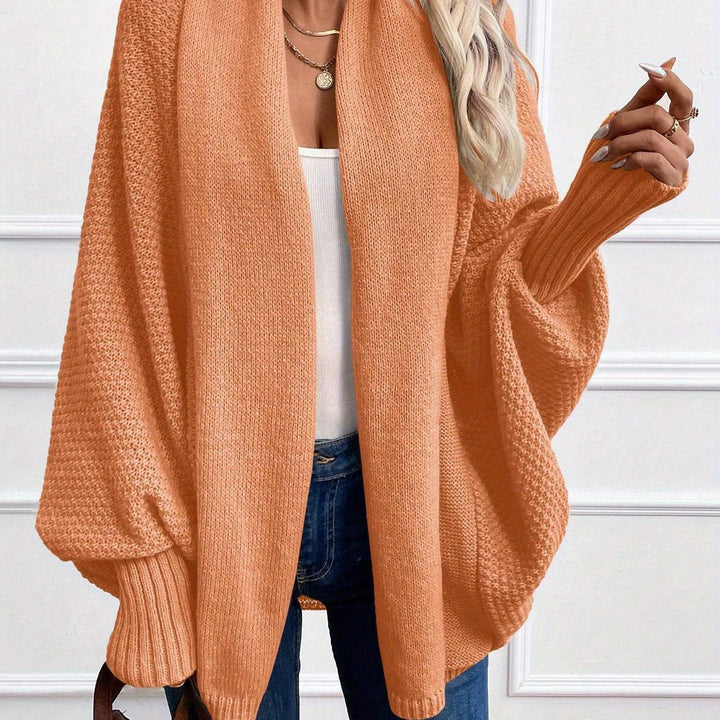 Harlow draped shawl collar cardigan in orange, front closeup