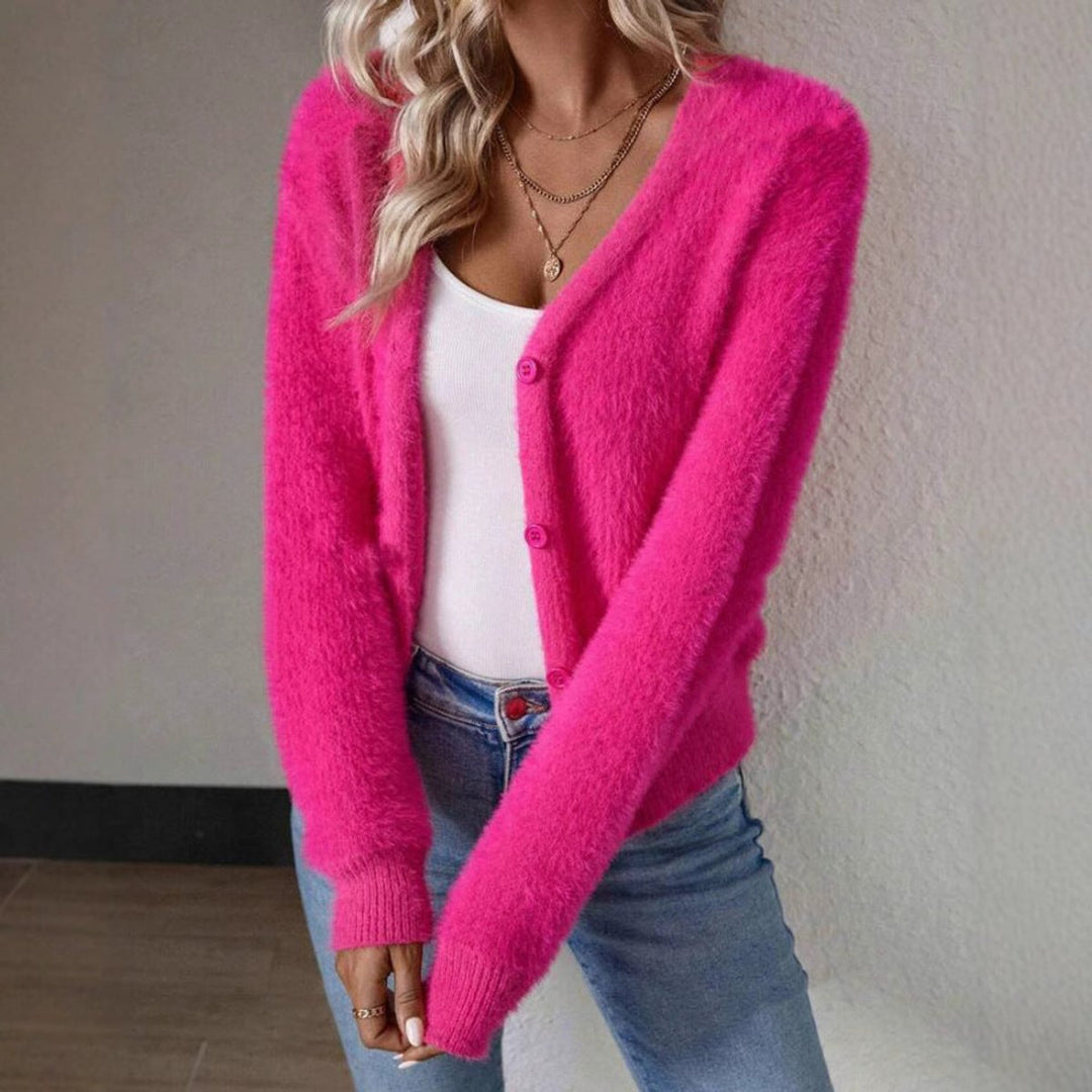 Harlow fuzzy pink cardigan, holding coffee cup, front view