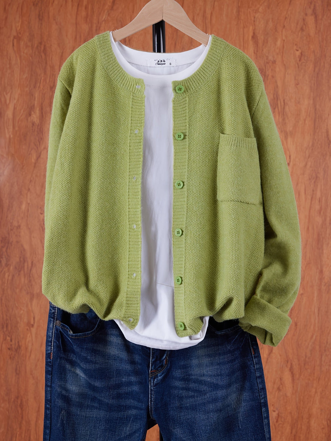 Harlow relaxed button-front cardigan in greenish yellow, front view on hanger