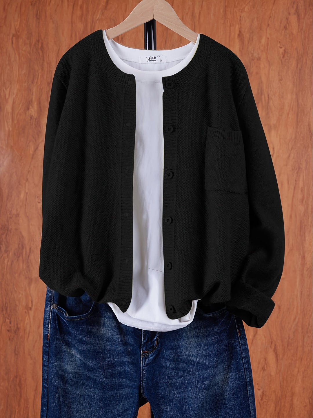 Harlow relaxed button-front cardigan in black, front view on hanger