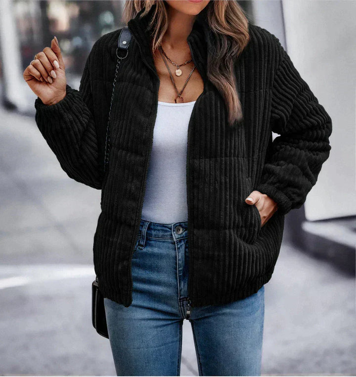 Harlow ribbed puffer jacket in black, front view with hand in pocket