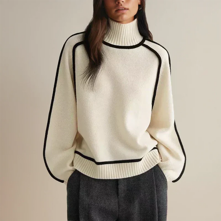 Isolde ivory turtleneck sweater with contrast trim, front view with trousers