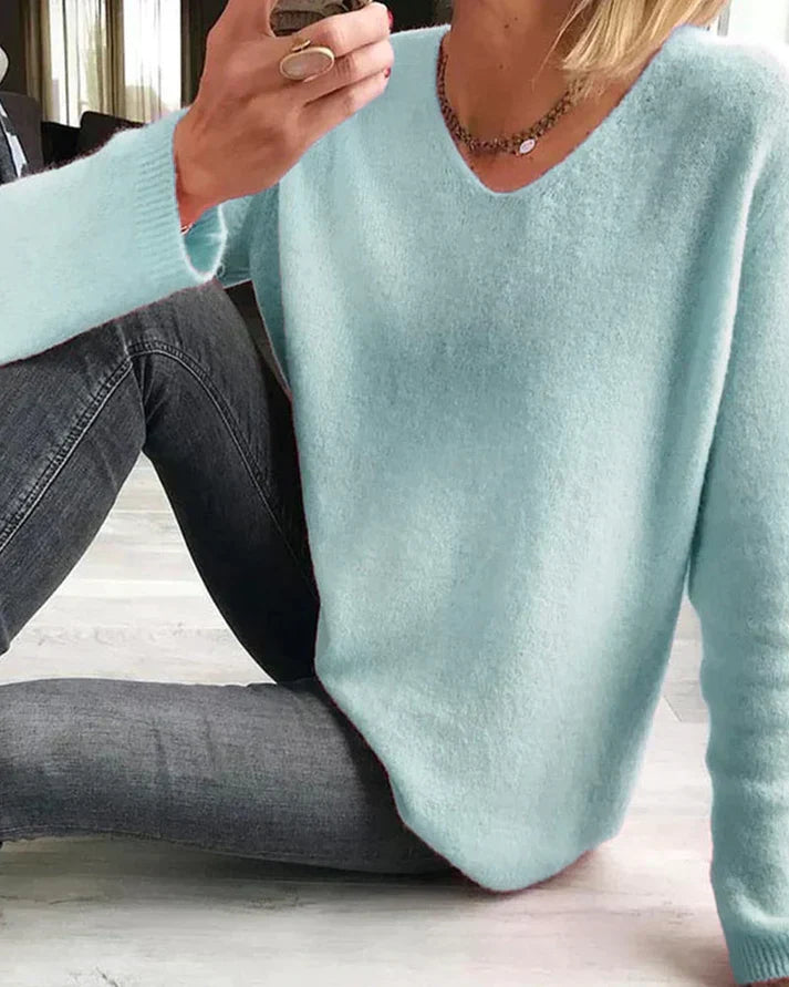 Margot v-neck long sleeve sweater in light blue, seated pose
