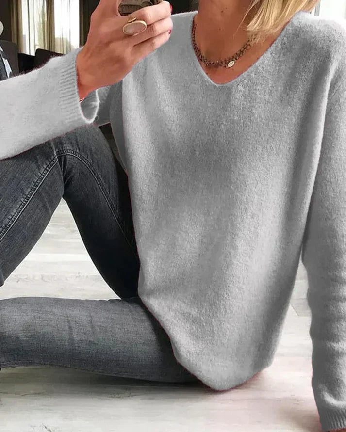 Margot v-neck long sleeve sweater in gray, seated pose