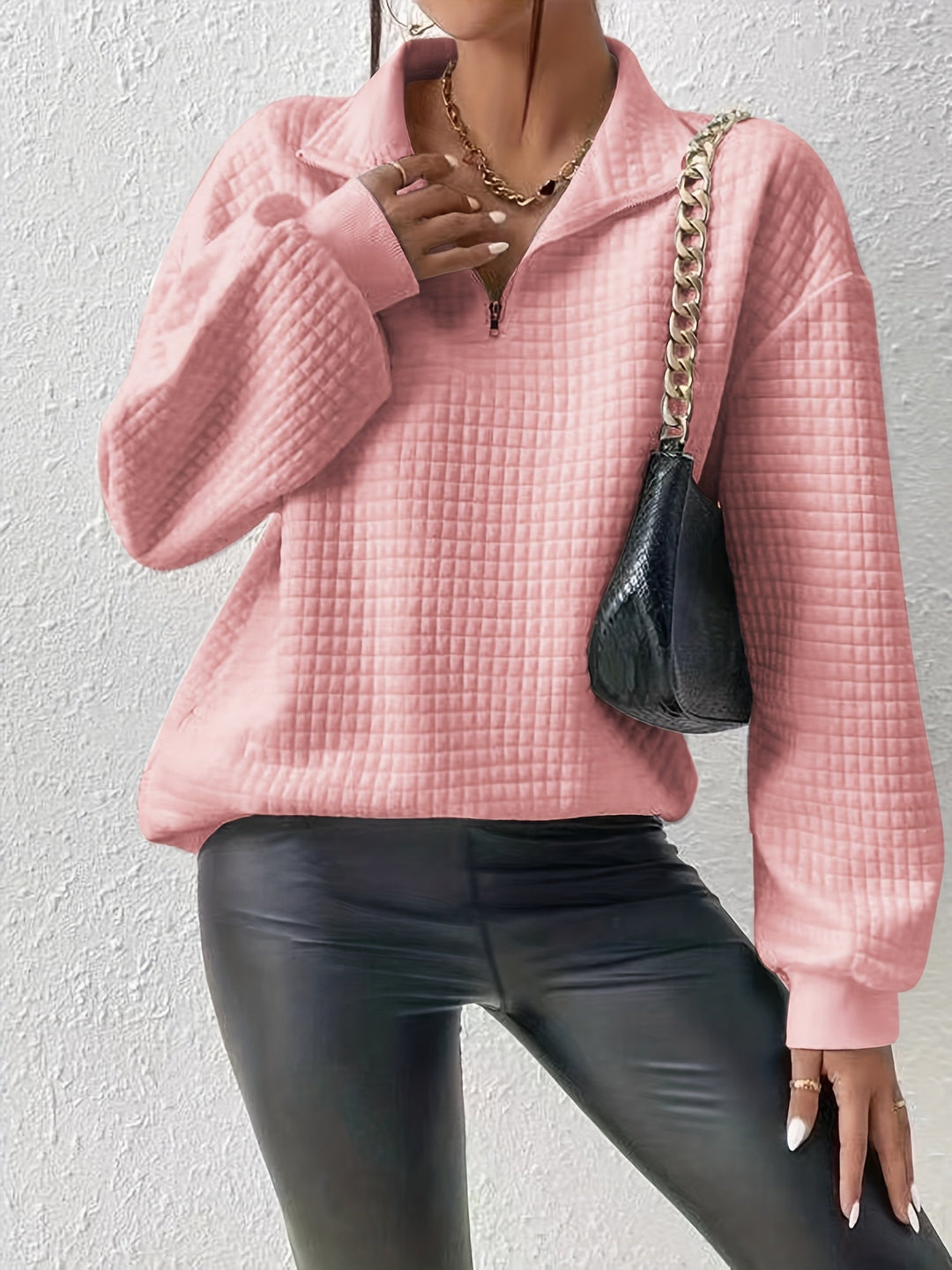 Marguerite pink textured quarter-zip pullover styled with black pants