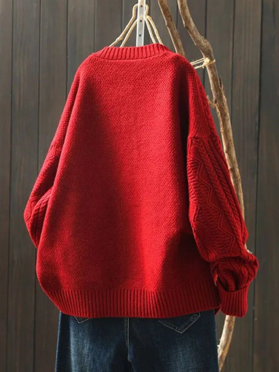 Marielle oversized cable knit button cardigan in red, back view on hanger