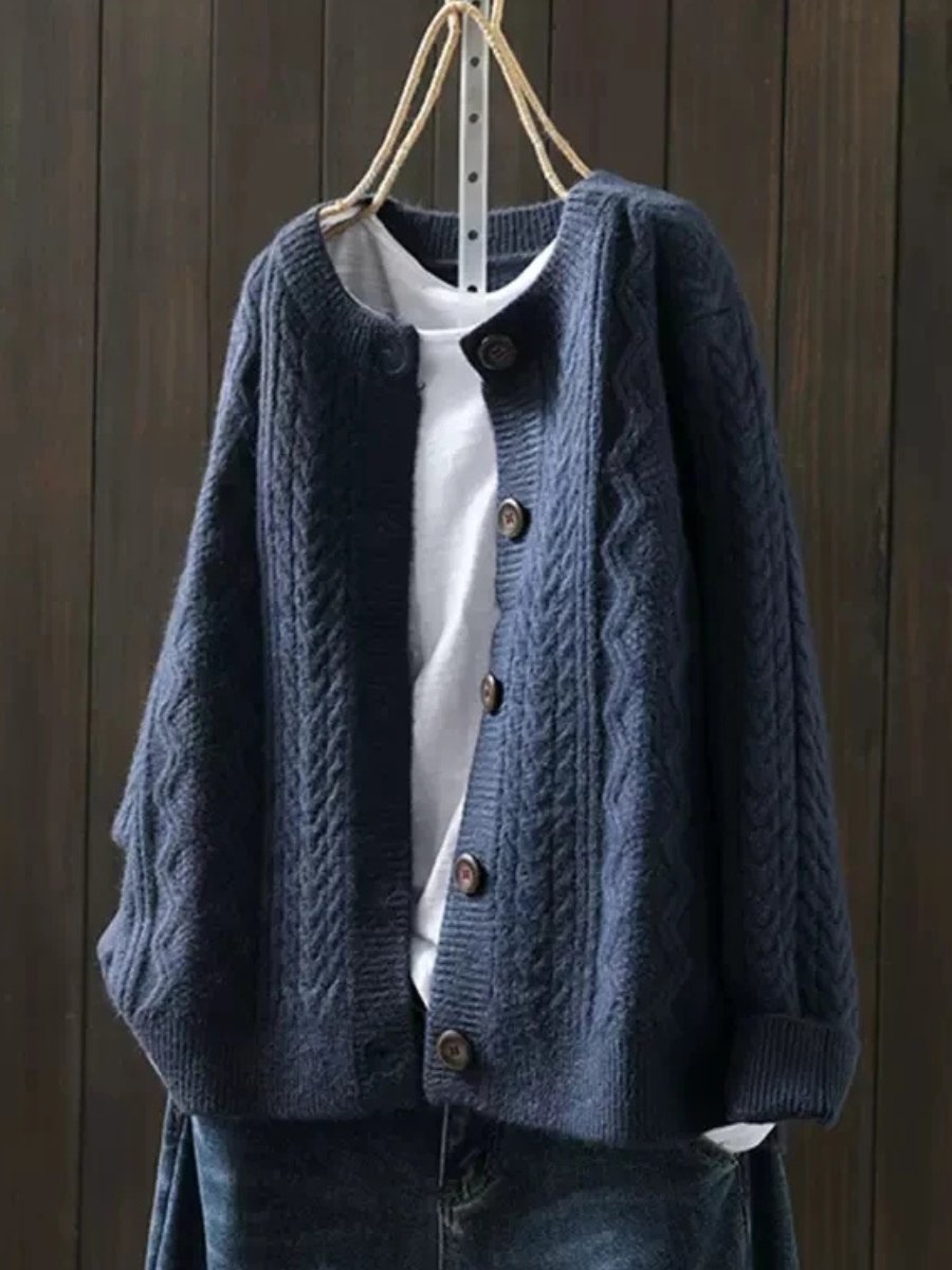 Marielle oversized cable knit button cardigan in navy blue, front view on hanger