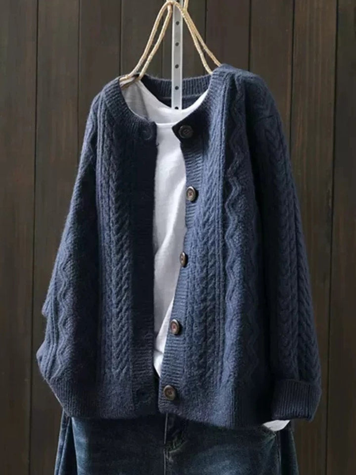 Marielle oversized cable knit button cardigan in navy blue, front view on hanger