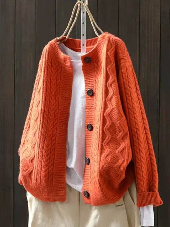 Marielle oversized cable knit button cardigan in orange, front view on hanger