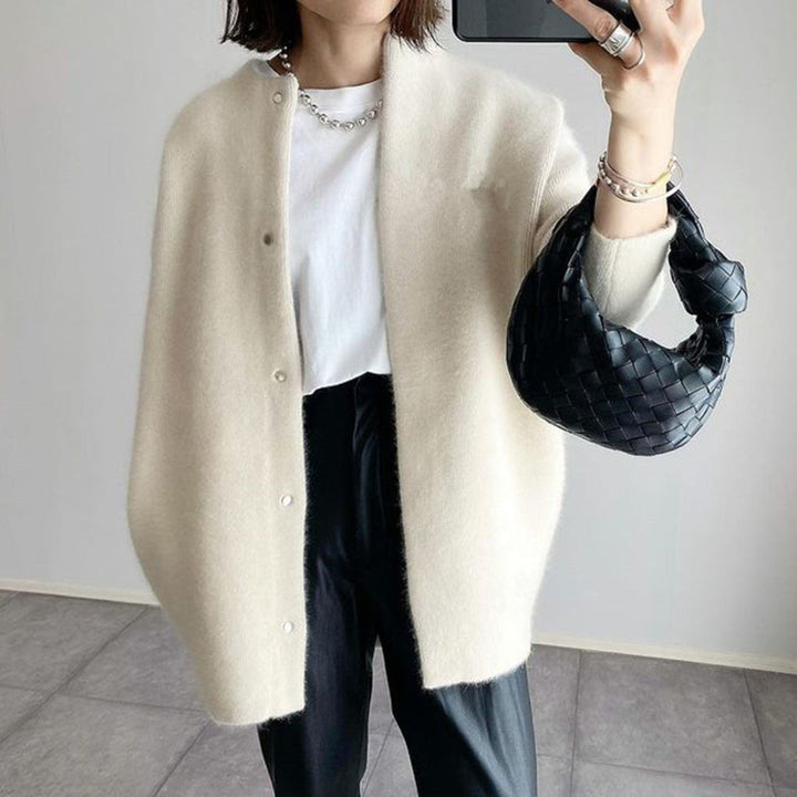 Marlowe fuzzy button down cardigan in cream, close-up with woven bag