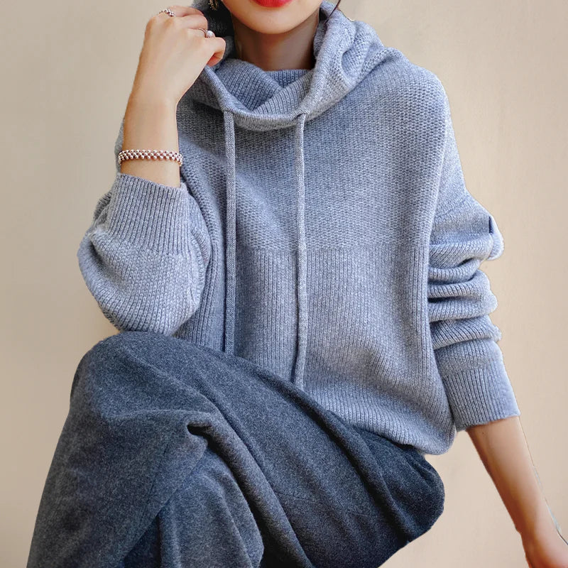 Marlowe cowl neck drawstring hooded sweater in gray-blue, seated lifestyle shot