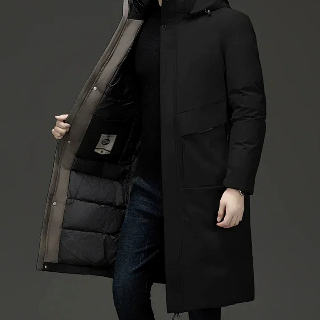 Grant insulated hooded long puffer coat in black, side view with hand opening front