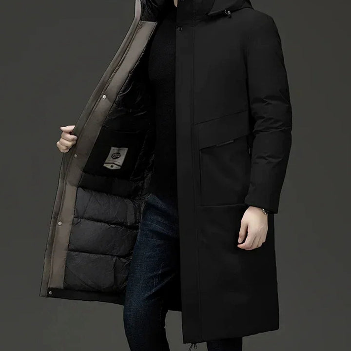 Grant insulated hooded long puffer coat in black, side view with hand opening front