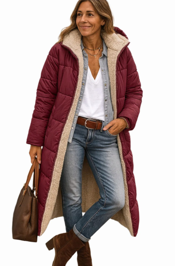 Rosalind long hooded sherpa jacket in wine red, front view holding a tote bag