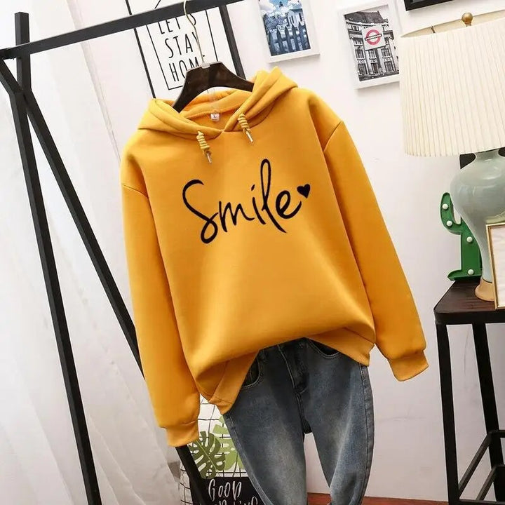 Willa oversized graphic print hoodie in yellow, front view on hanger