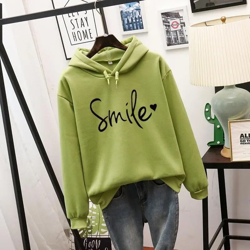 Willa oversized graphic print hoodie in green, front view on hanger
