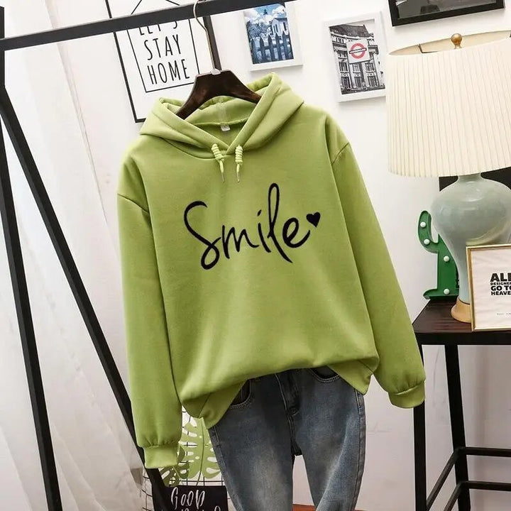 Willa oversized graphic print hoodie in green, front view on hanger