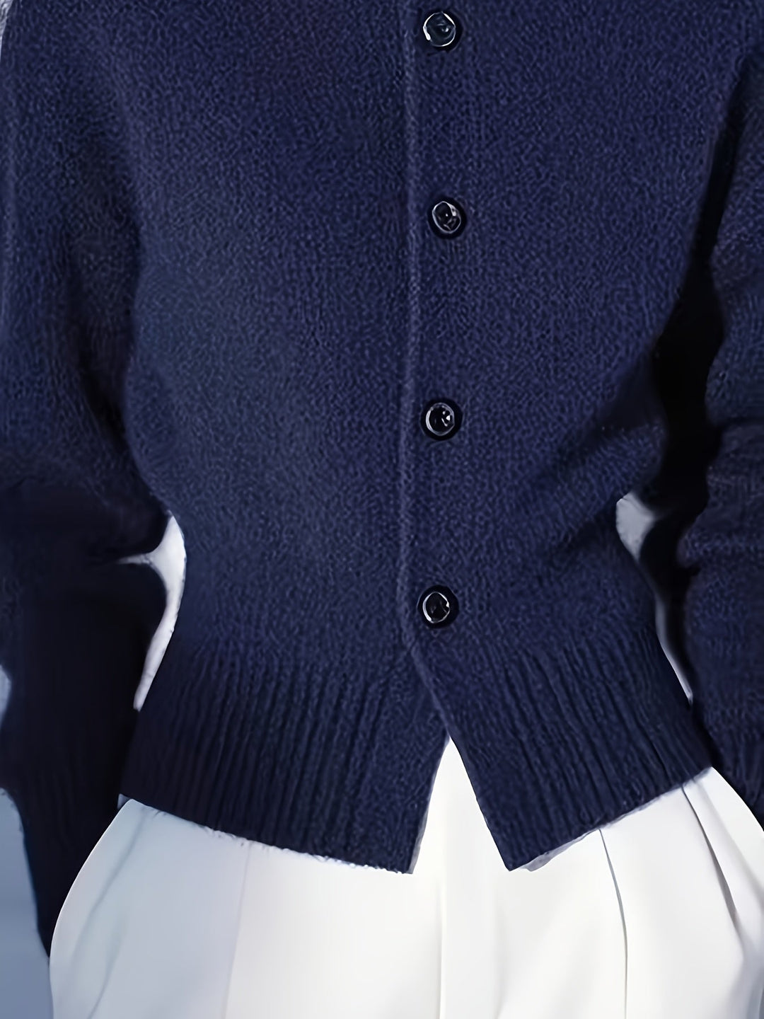 Wren navy high-neck button cardigan, hem and button close-up
